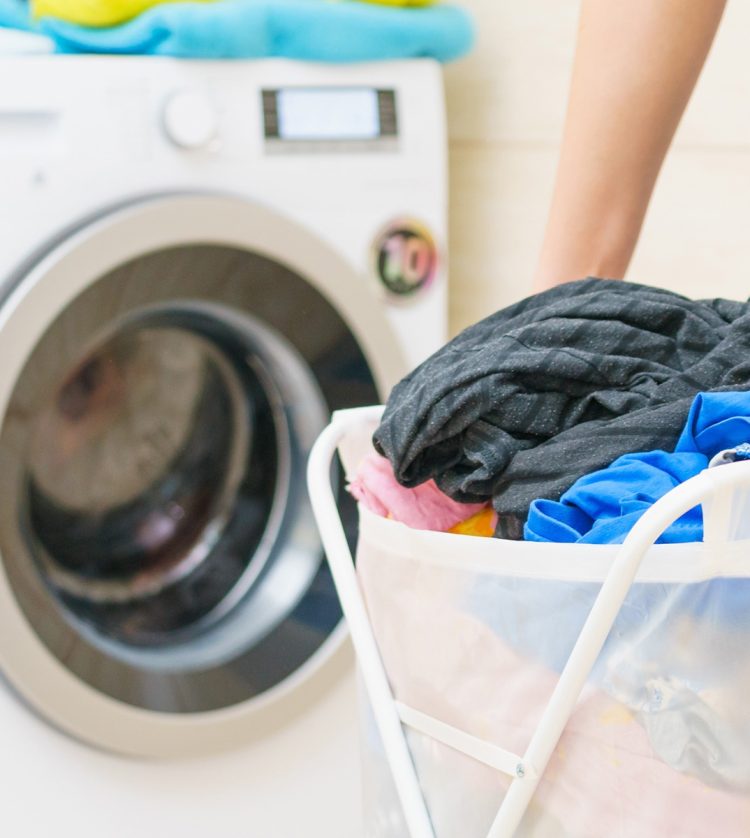 Woman Washing and Holding Basket With Clothes